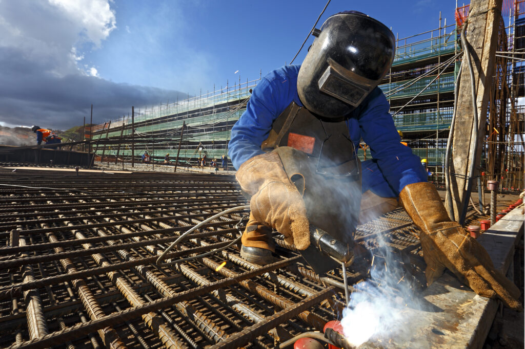 Welding Worker Welding Steel Structure On Construction Site